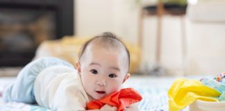 Bé 7 tháng tuổi đã có thể ngồi vững và chủ động với lấy đồ vật